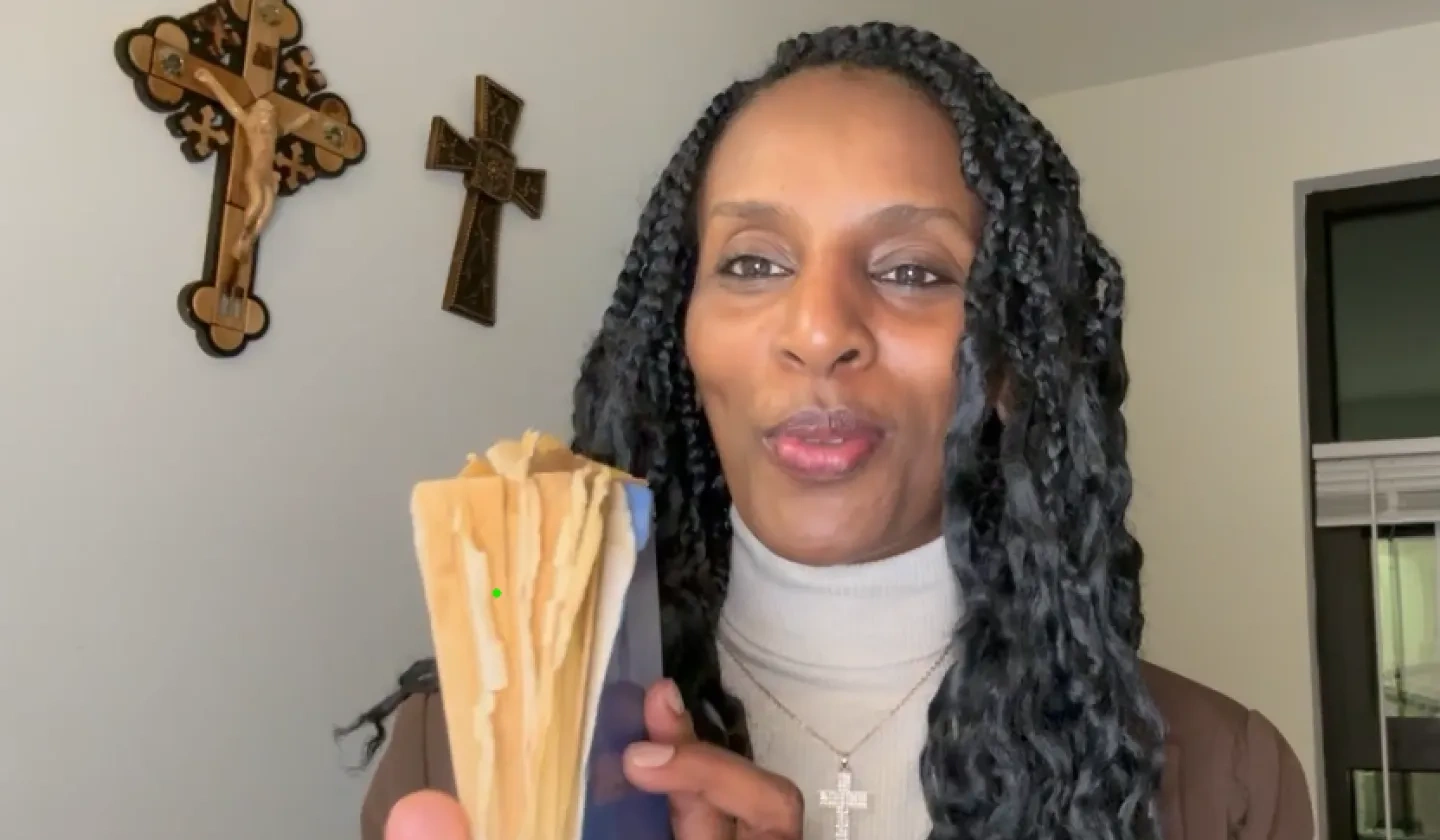 Picture of Mariam Ibrahim holding her prison Bible which she hid in her hair while imprisoned