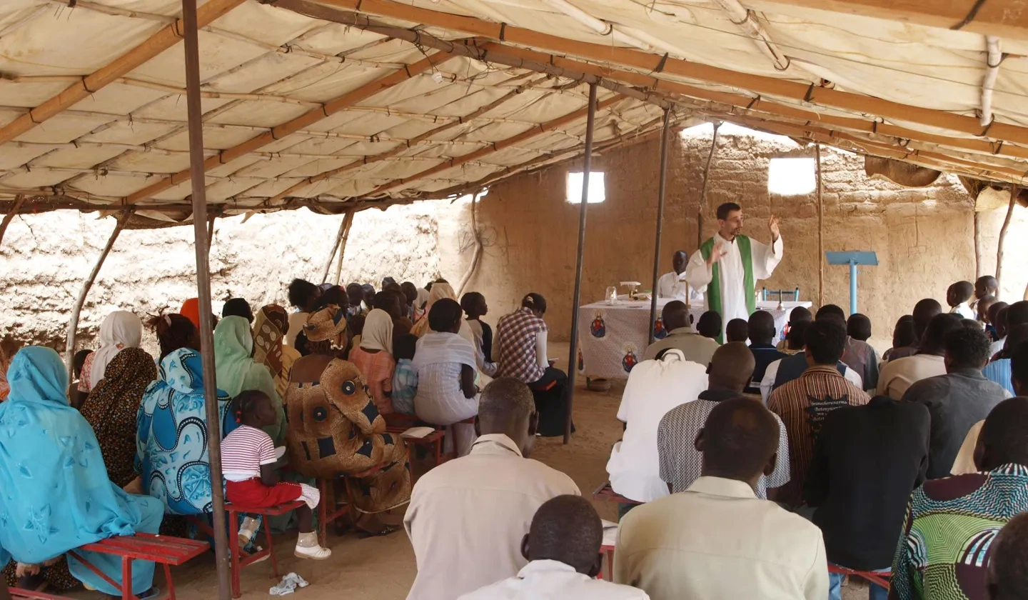 Priest with his community in Sudan