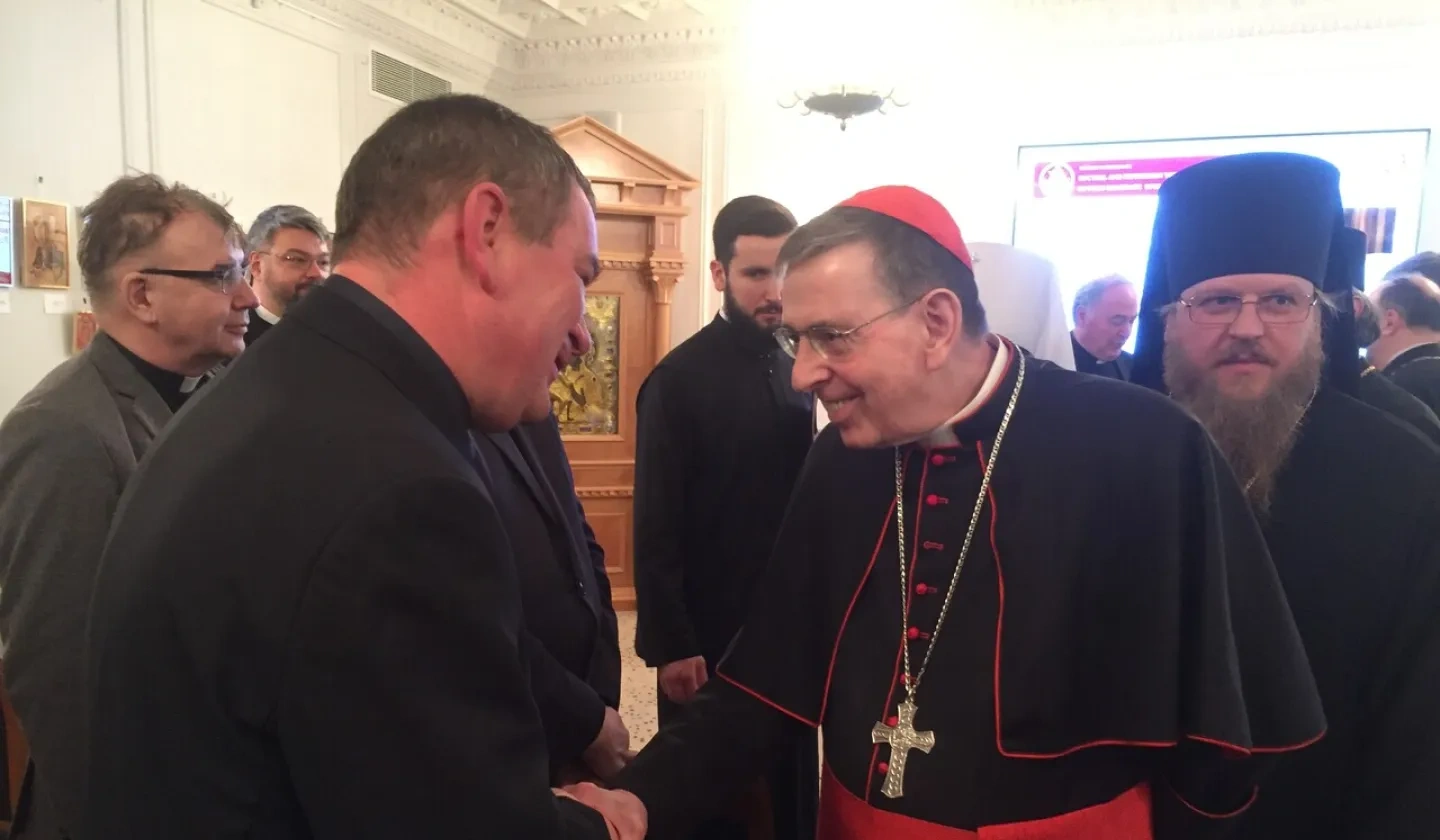 Cardinal Kurt Koch shaking hands with a person.