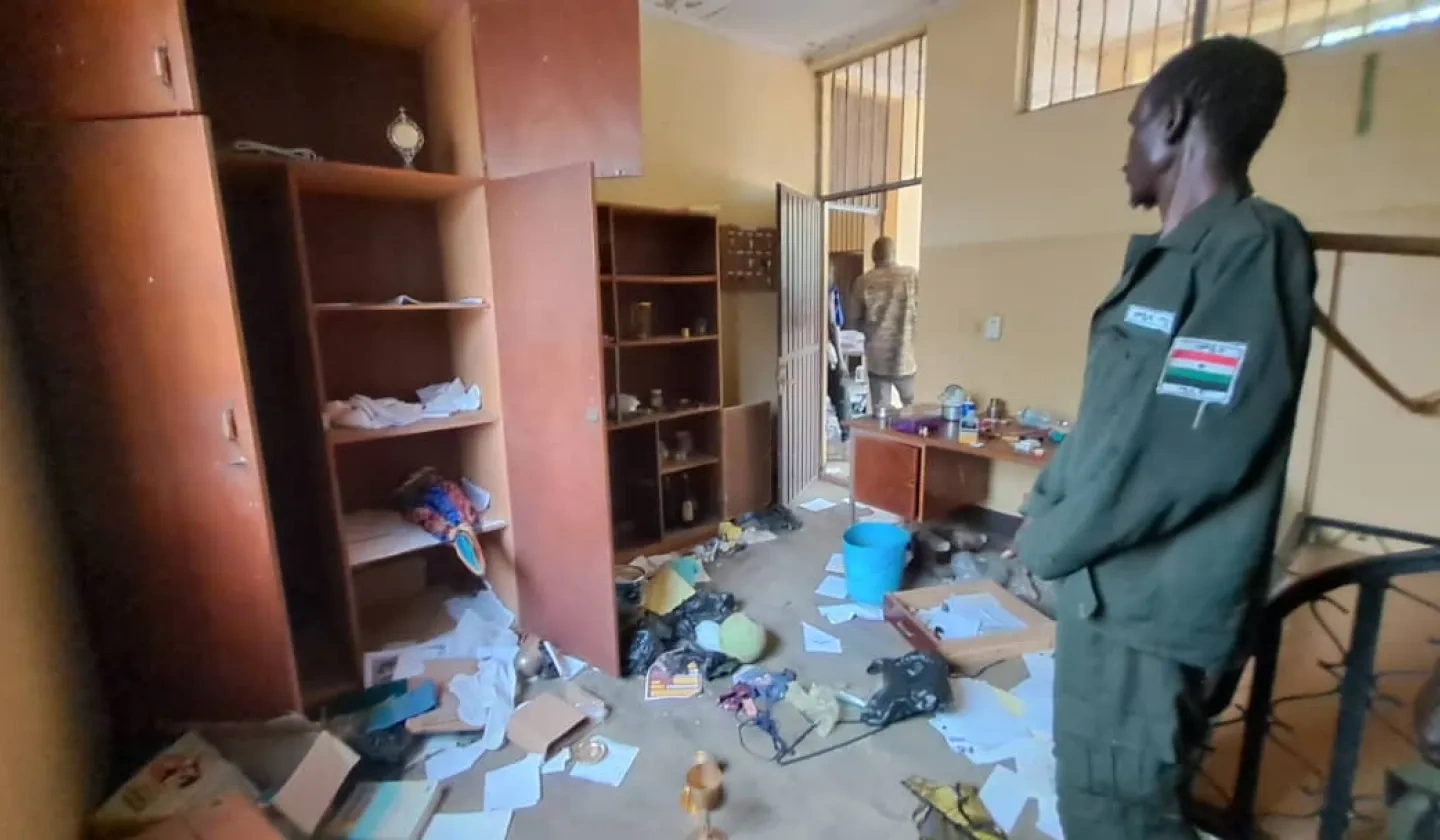 Man looks at room trashed by clashing tribes