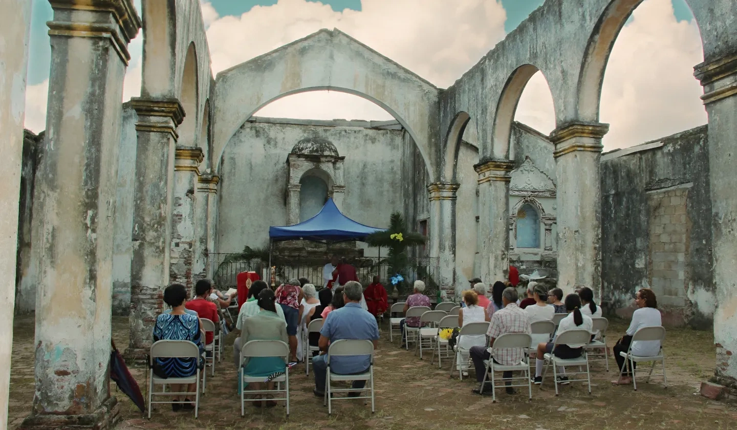 service taking place in a demolished church in Floro Perez