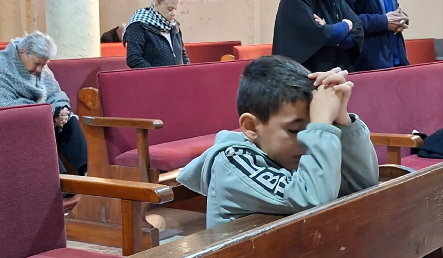 Young boy praying in Gaza