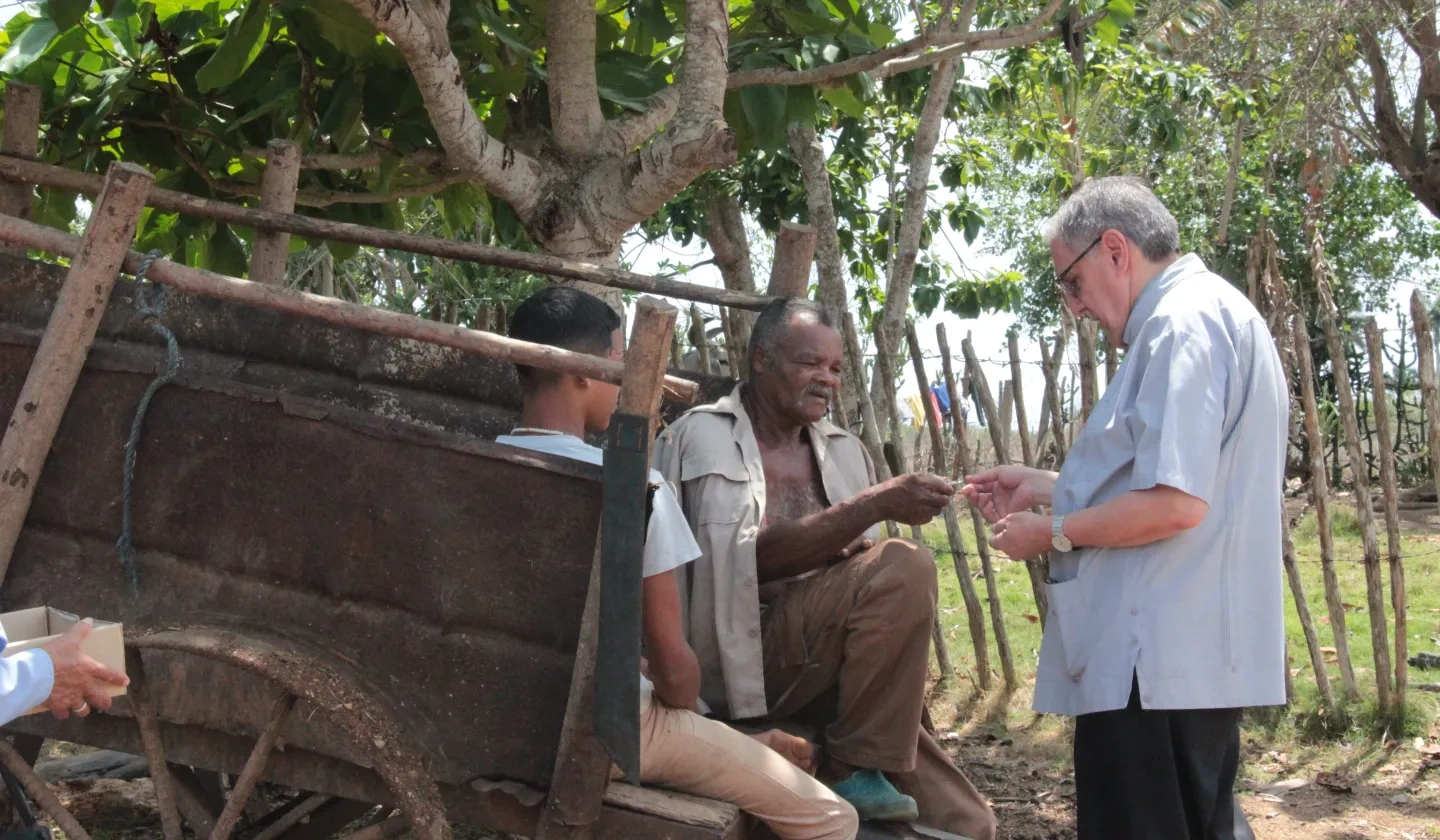 Bishop Arturo Gonzalez of Santa Clara, talking with some people in the countryside 
