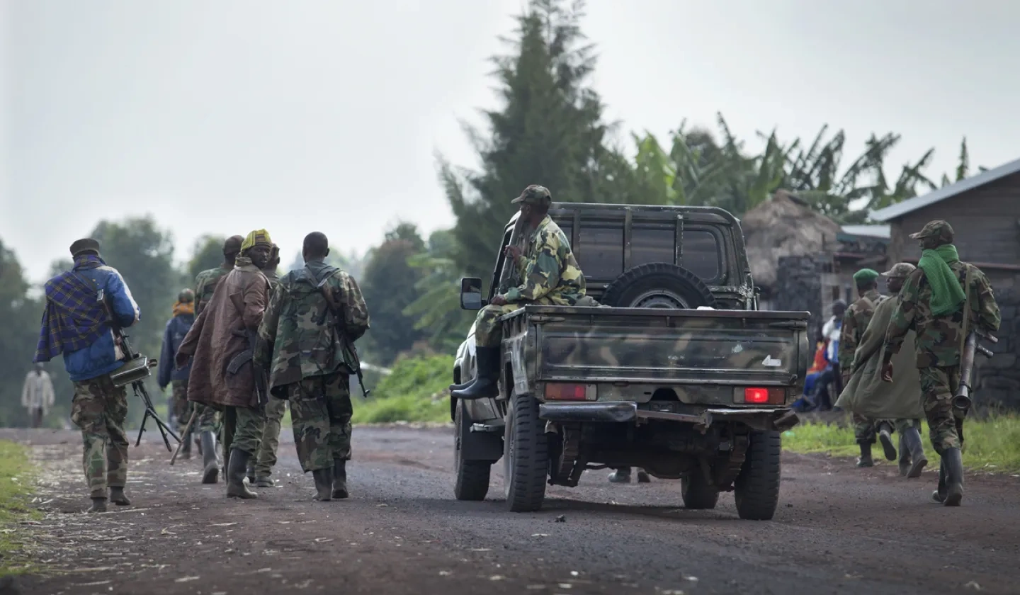 M23 fighters loyal to Rwanda move along the road towards Goma
