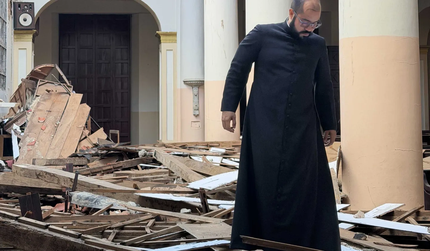 Priest investigating church ruins in Venezuela 