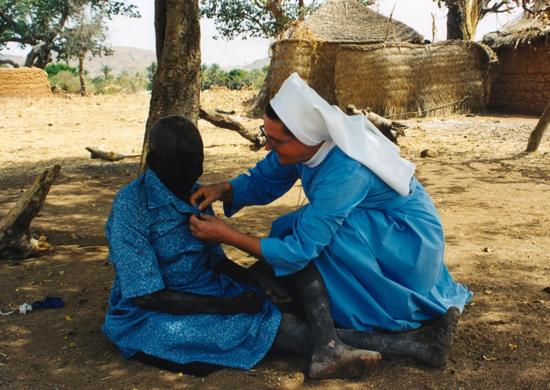 Sister with the woman sick from the leprosy
