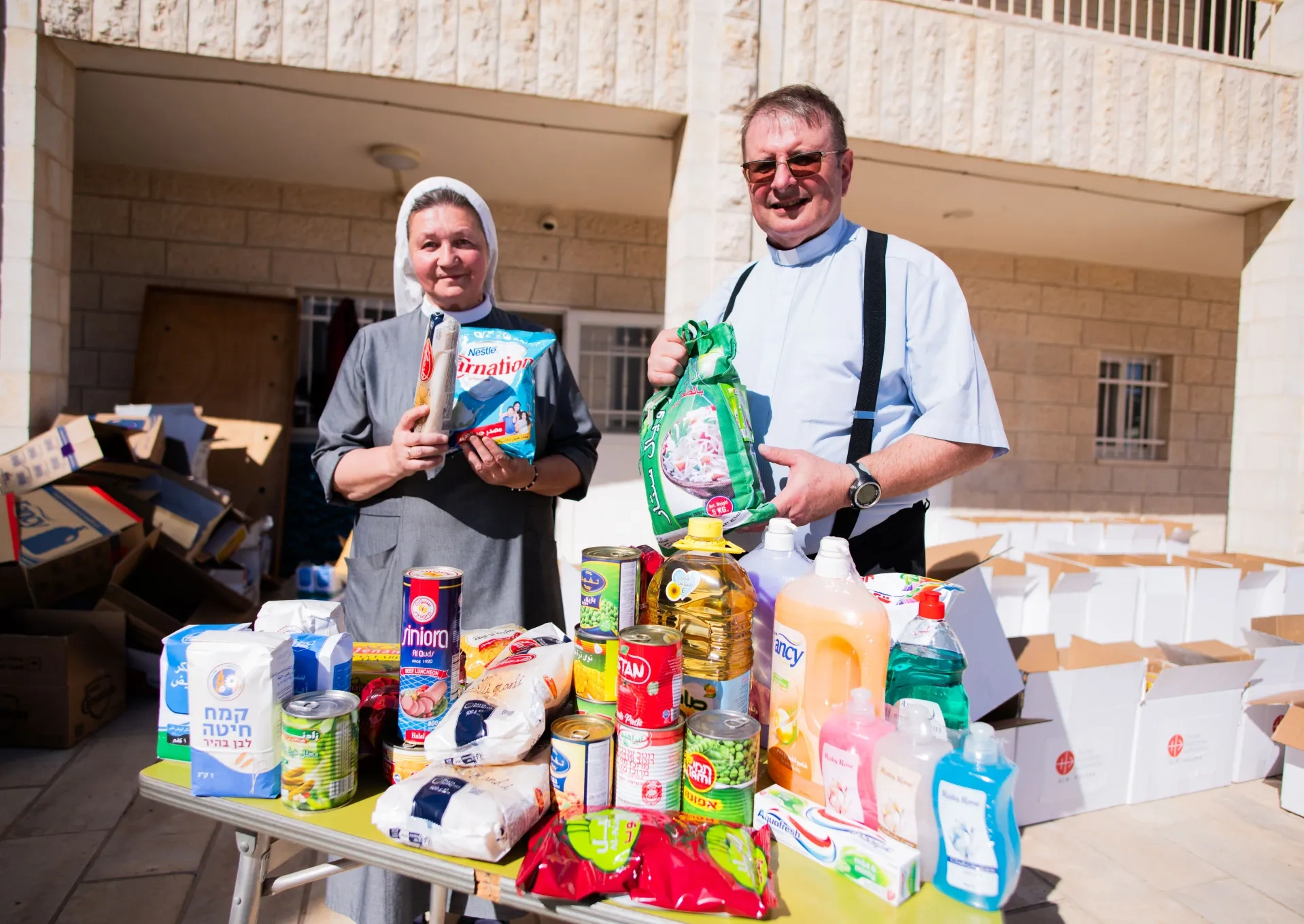 Priest and Sister with food parcels in the Holy Land