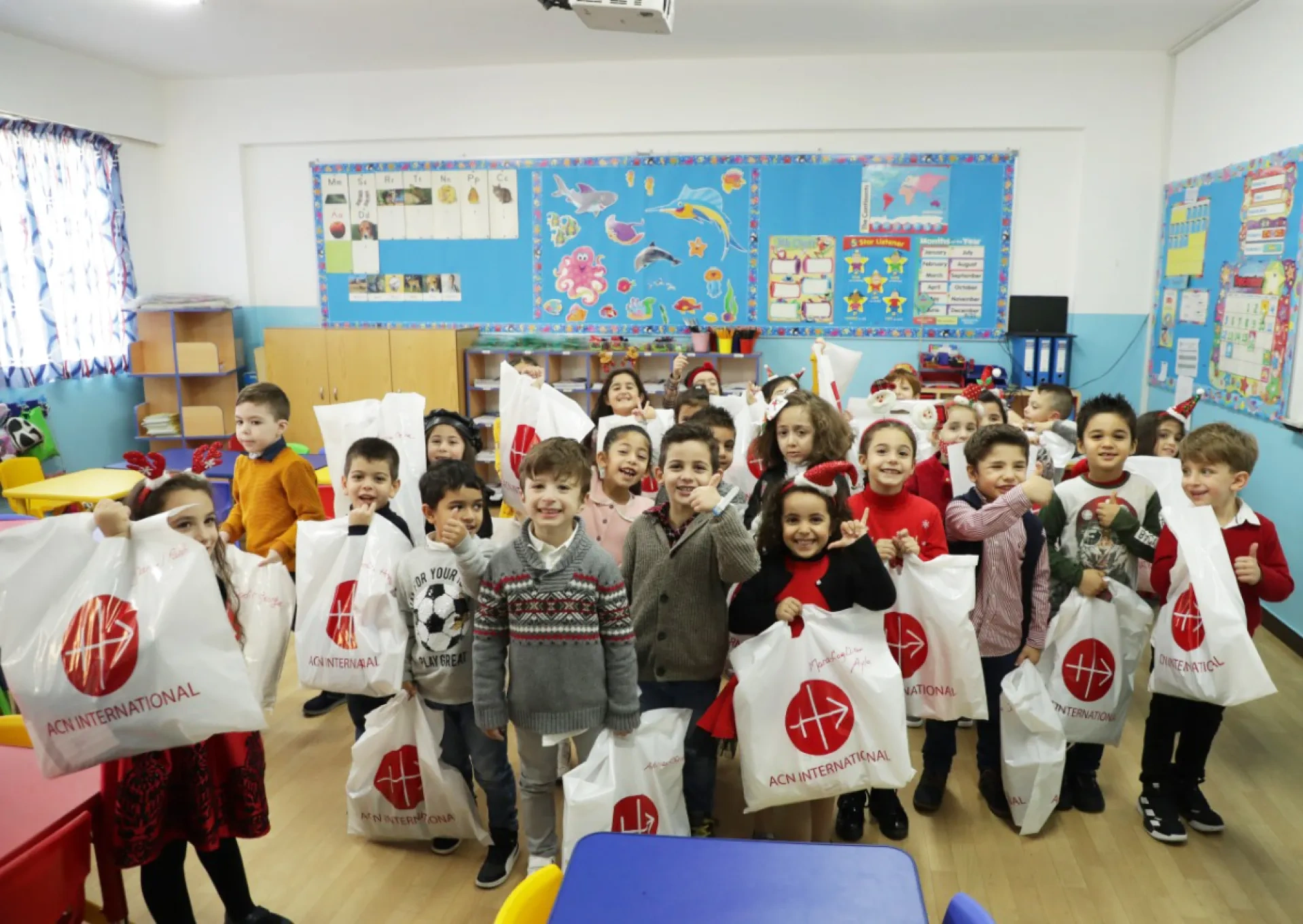 Children receiving Christmas gifts from ACN
