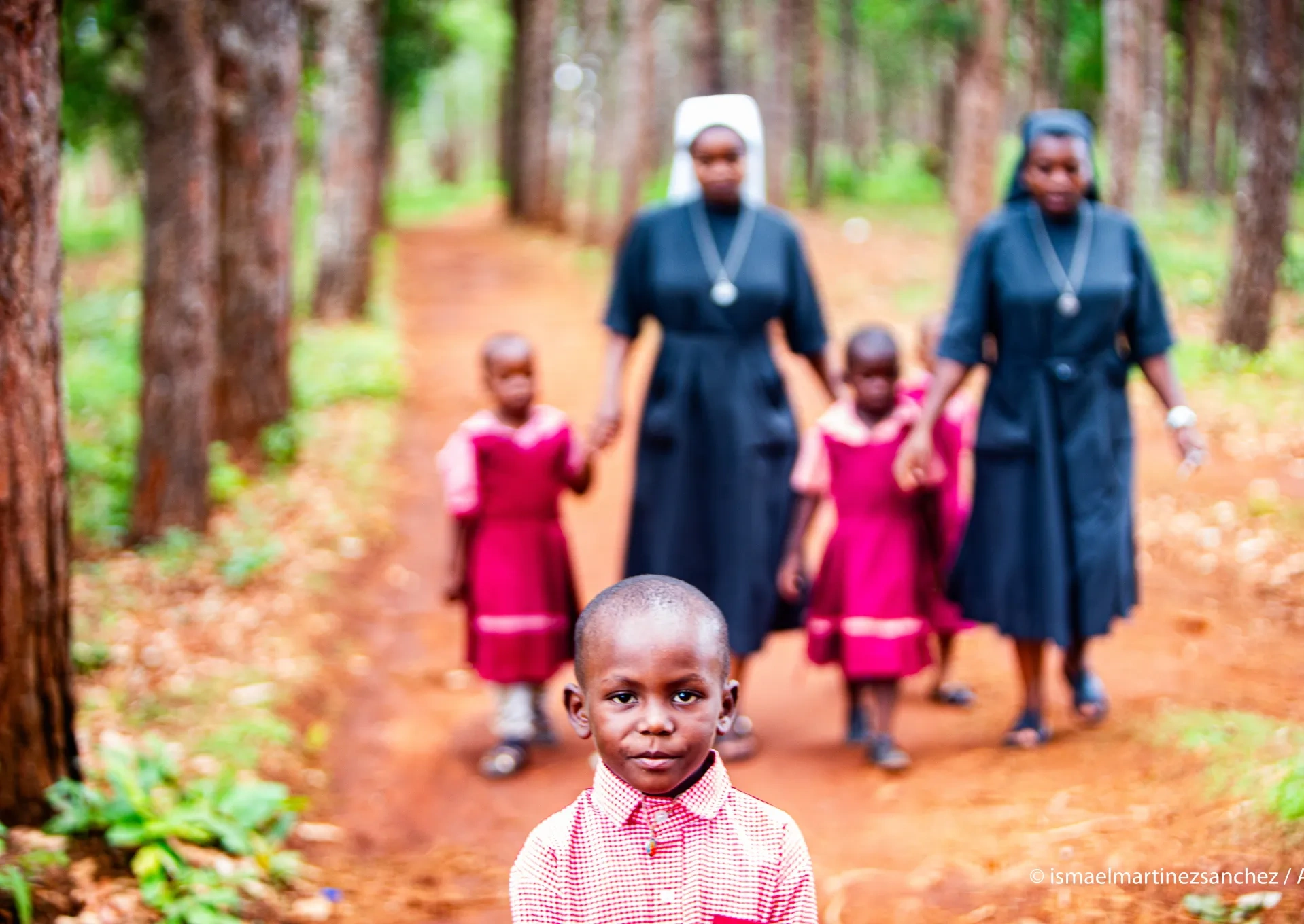 Sisters helping young girls in a forest