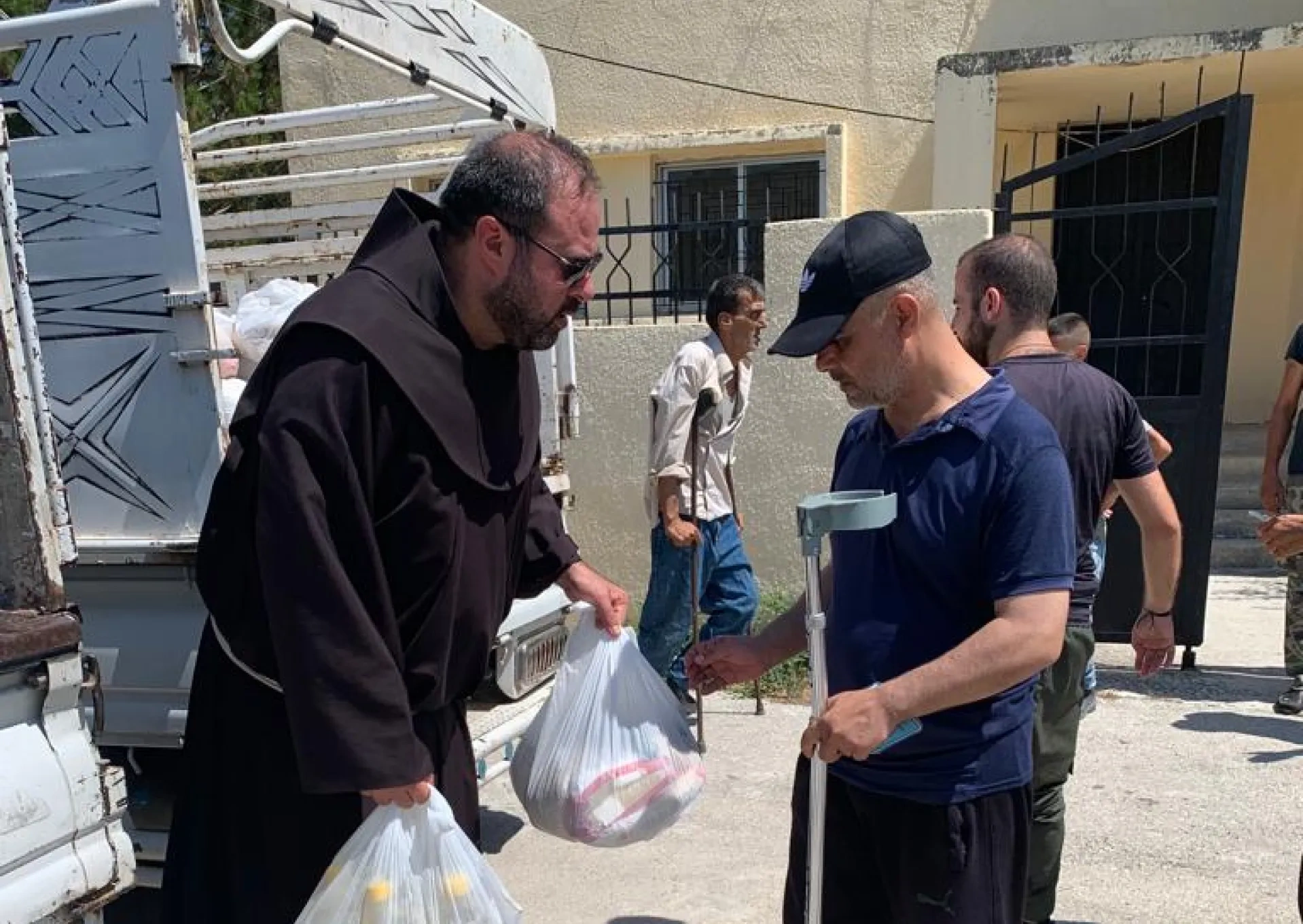 A priest helping a person in need receive aid