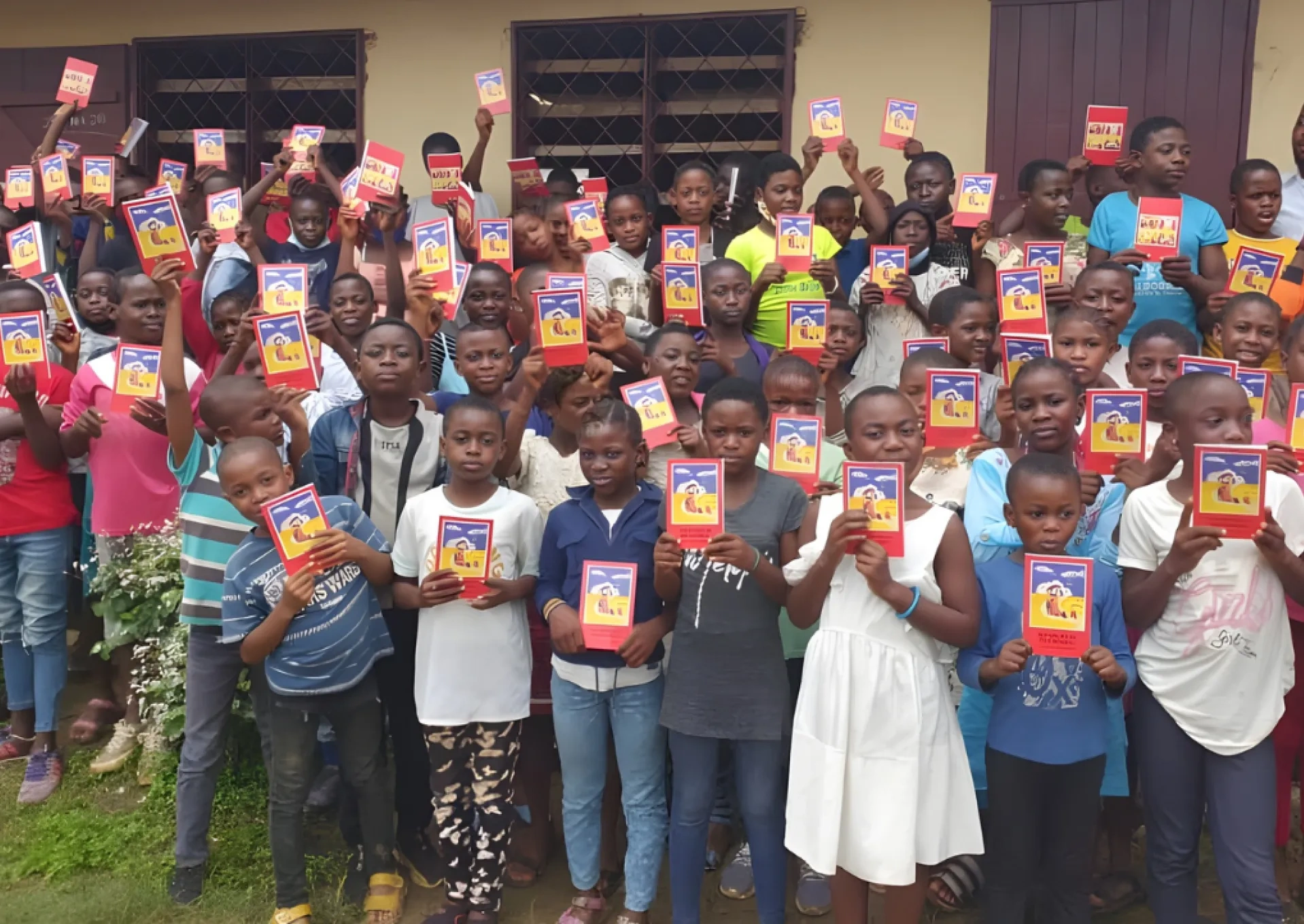Children holding the ACN Childs Bible