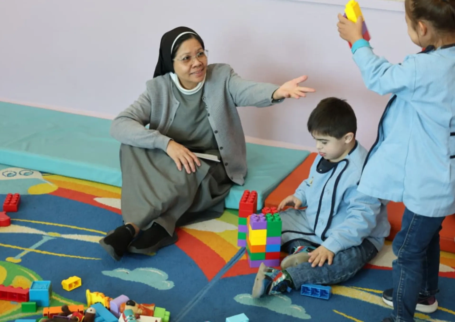 A Sister, supporting children at nursery