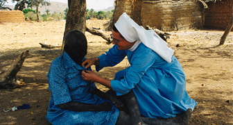 Sister with the woman sick from the leprosy