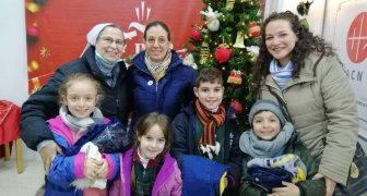 Sister and family receiving Christmas gifts.