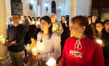People praying in Mass in the Holy Land