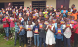 Children holding the ACN Childs Bible