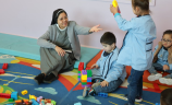 A Sister, supporting children at nursery