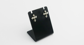 Two silver cross earrings on a black stand
