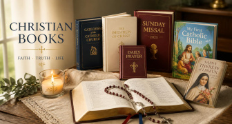 A selection of Christian books on a desk with a candle and rosary
