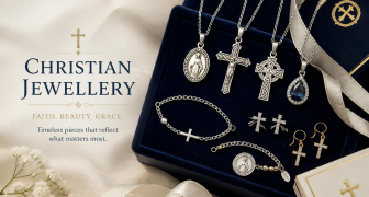 A selection of silver Christian jewellery displayed on a velvet blue display