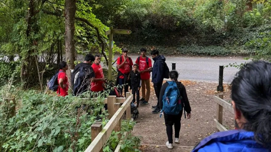 Family walking in a forest during fundraising activity