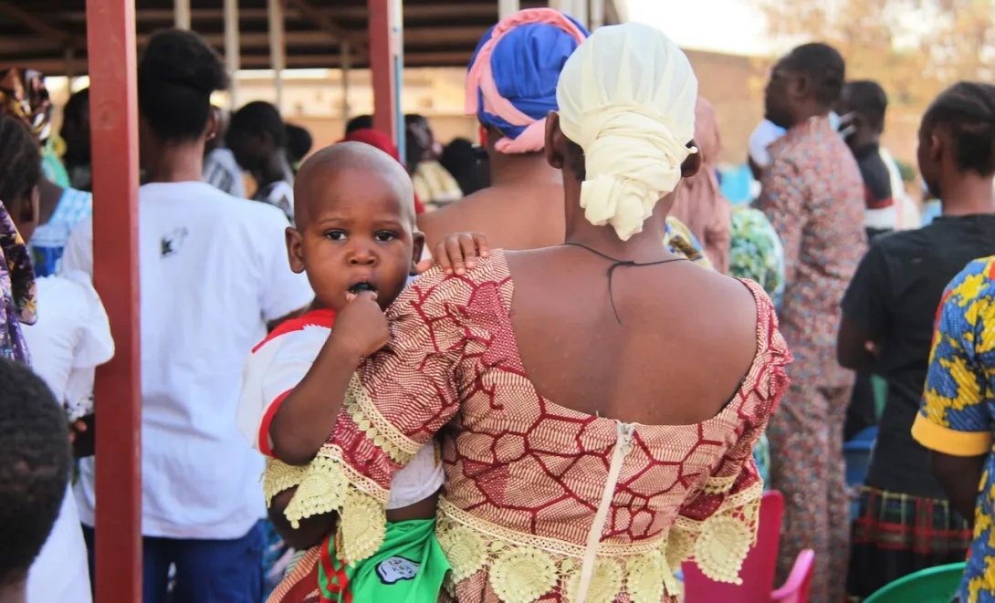 A child being held by it's mother in Burkina Faso