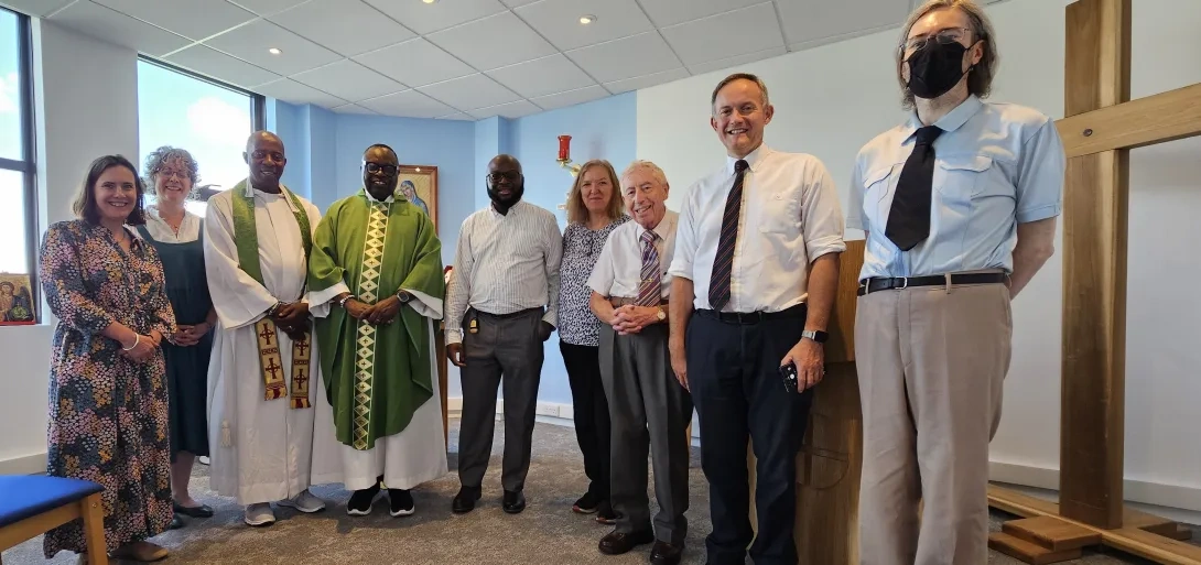 Two priests joined by others after celebrating Mass