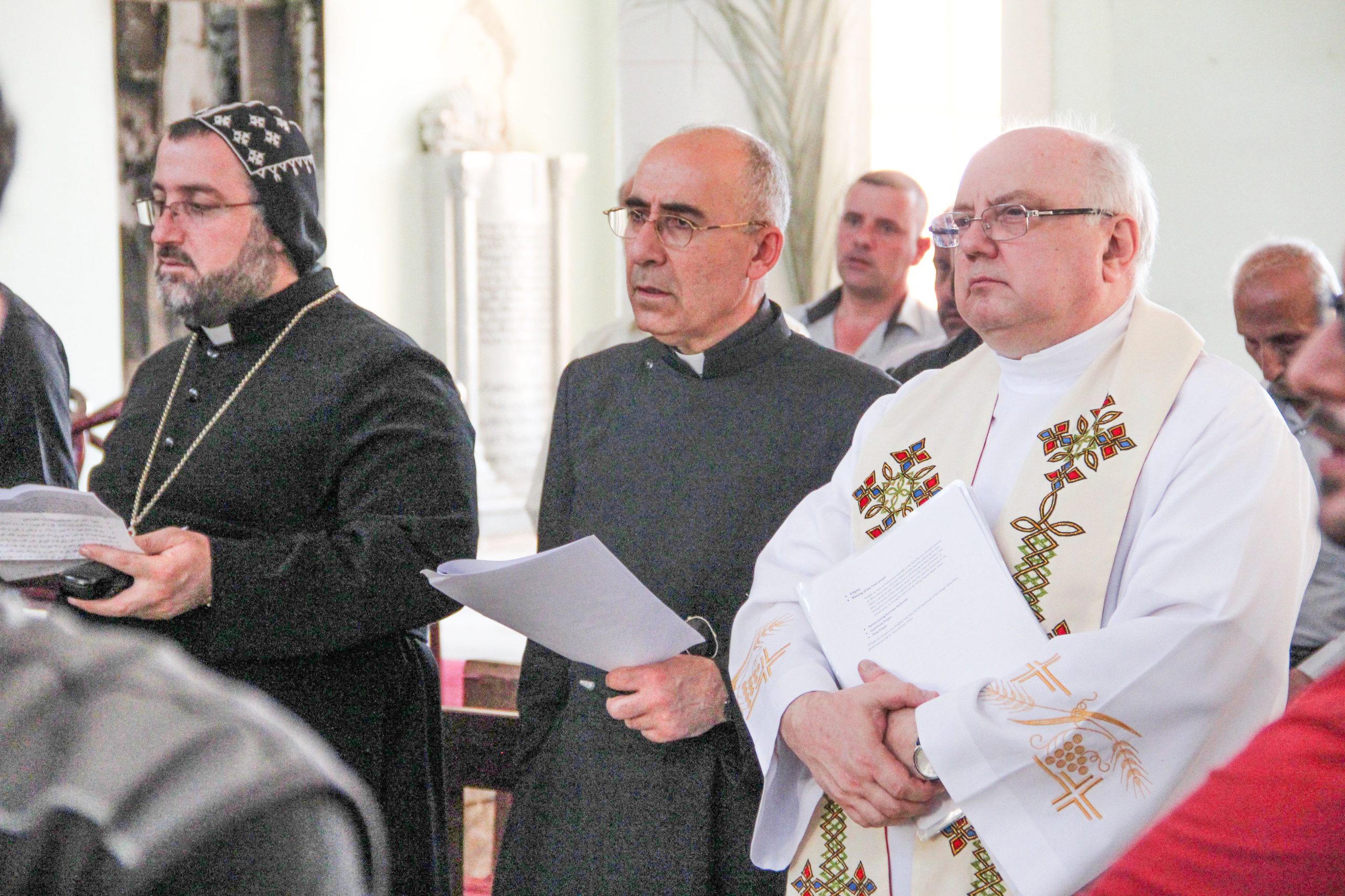 Fr Andrzej Halemba, Aid to the Church in Need’s Middle East projects coordinator (right) with Syriac Catholic priest, Fr Georges Johola (centre) in the Middle East (© Aid to the Church in Need)