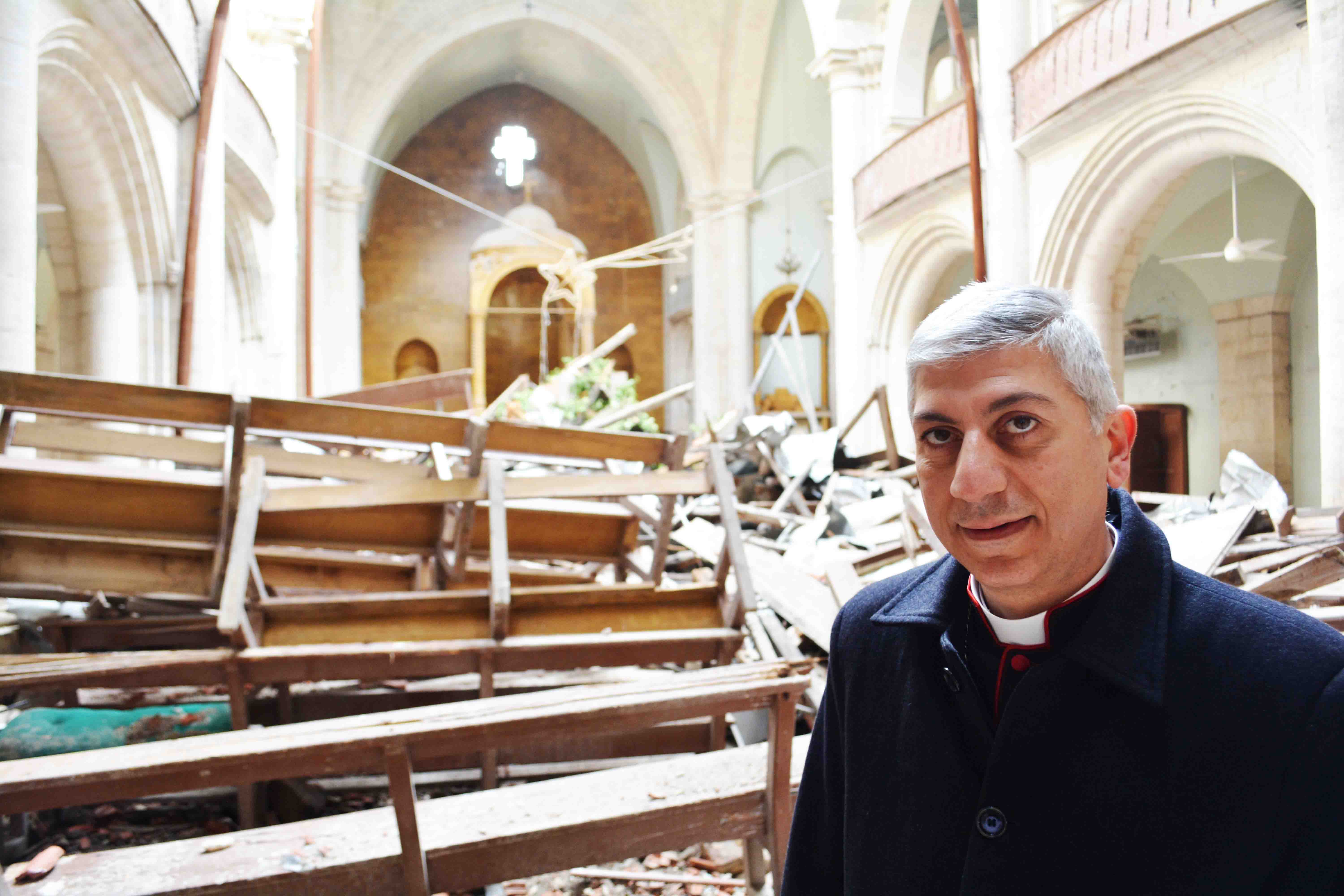 Maronite Archbishop Joseph Tobji in the bombed Maronite Cathedral in Aleppo's Old City