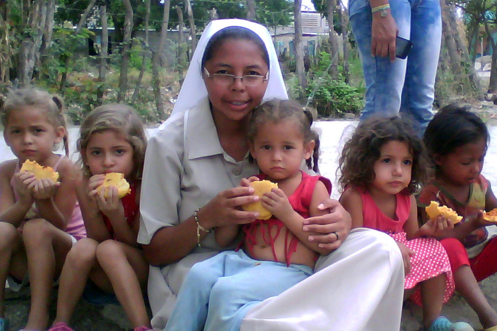 Sister feeding Venezuelan children (© ACN)