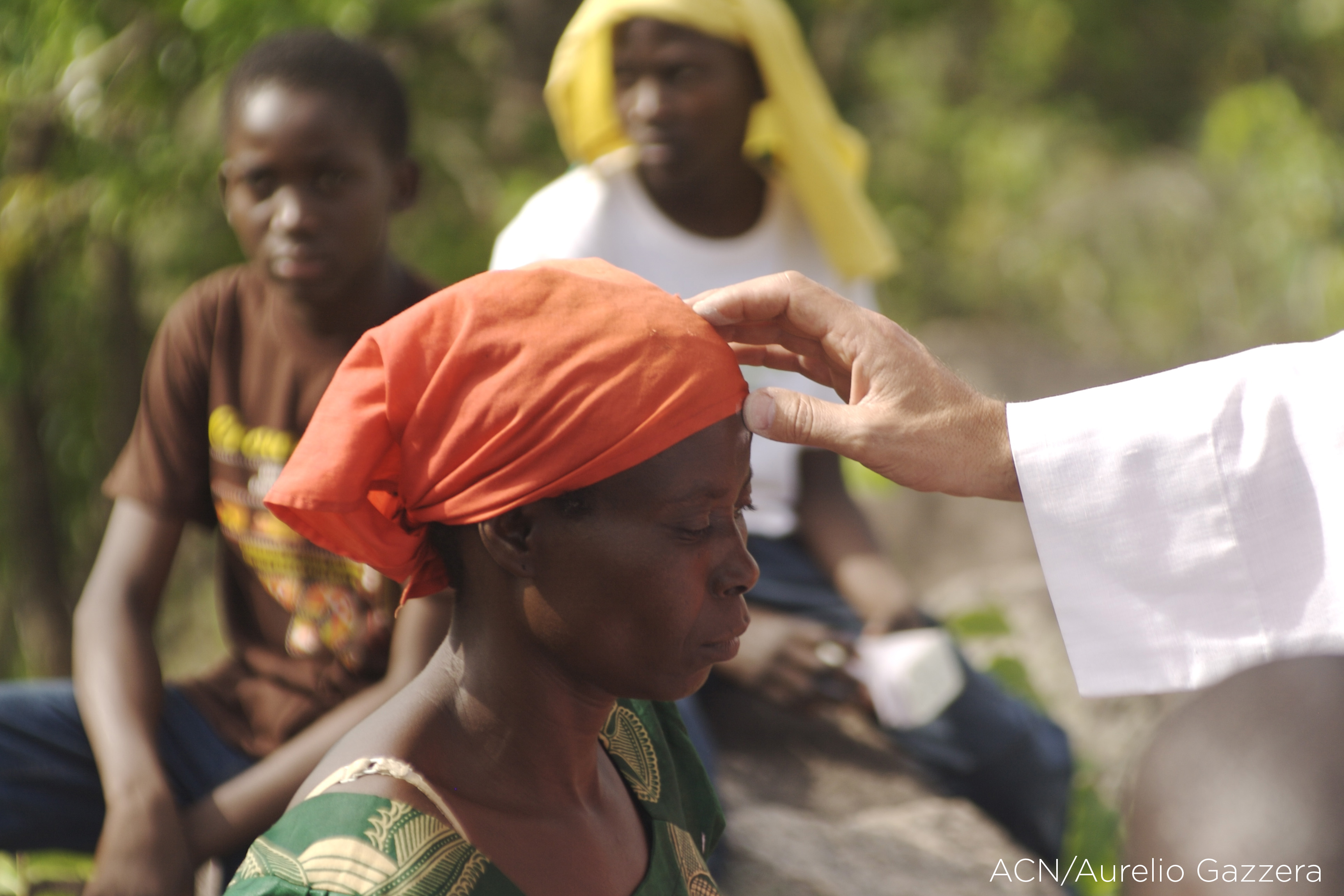Central African Republic, Bozoum, priest placing a cross of ashes on a woman's forehead on Ash Wednesday