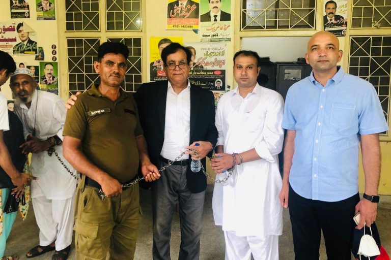 With image of Asif Pervaiz (second right with handcuffs) with Sajid Christopher (far right) (© Tanveer Bhatti)