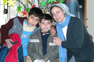 Sister Annie Demerjian and children with anoraks © Aid to the Church in Need