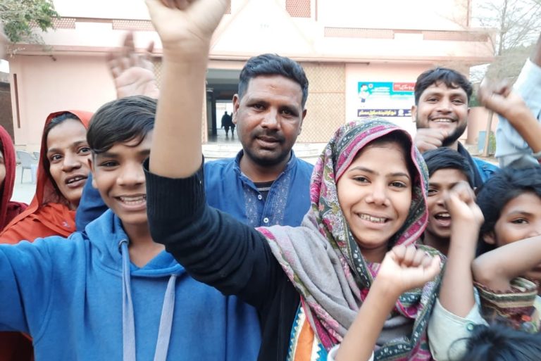 With pictures of Farah Shaheen (centre right with headscarf) reunited with her family (© Bishop Iftikhar Indryas/Aid to the Church in Need)