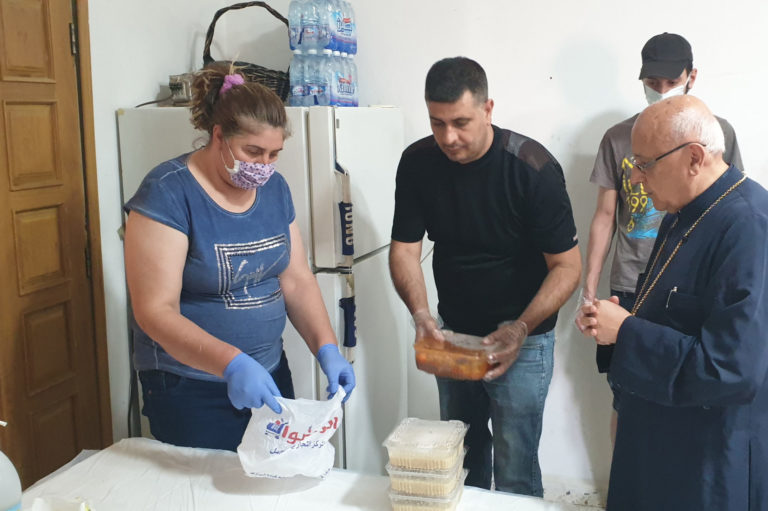 Preparing to distribute food to Syrian refugees, observing Lebanese COVID-19 safety guidance.