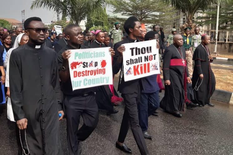 With picture of Catholics protesting the killing of Christians in 2020 (© Aid to the Church in Need)