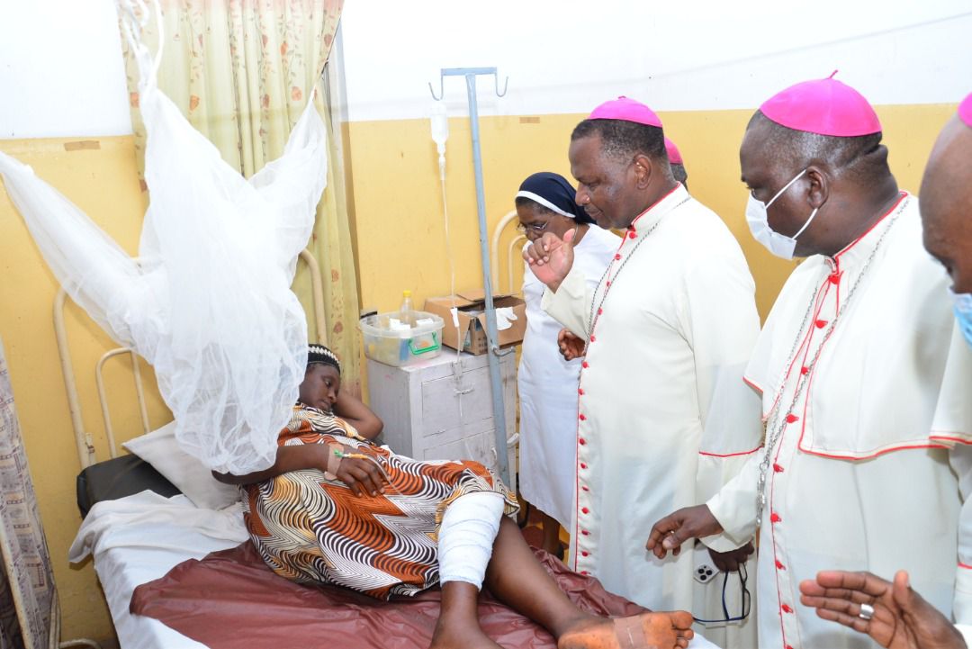 Bishop Jude Arogundade (without mask), visiting a survivor of the attack on St Francis Xavier's Catholic Church.
