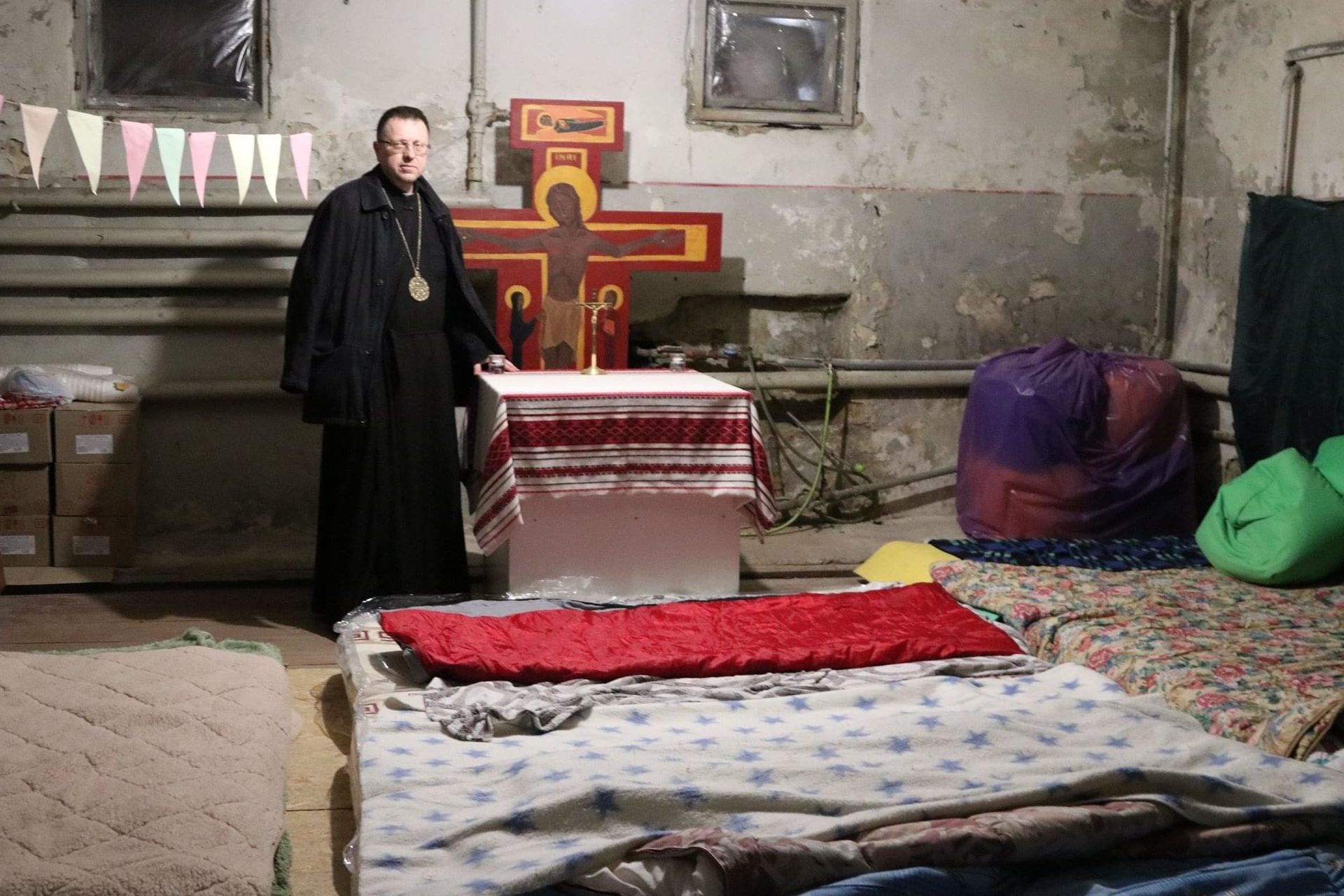 Auxiliary Bishop Volodymyr Hrutsa in the chapel of an underground shelter.