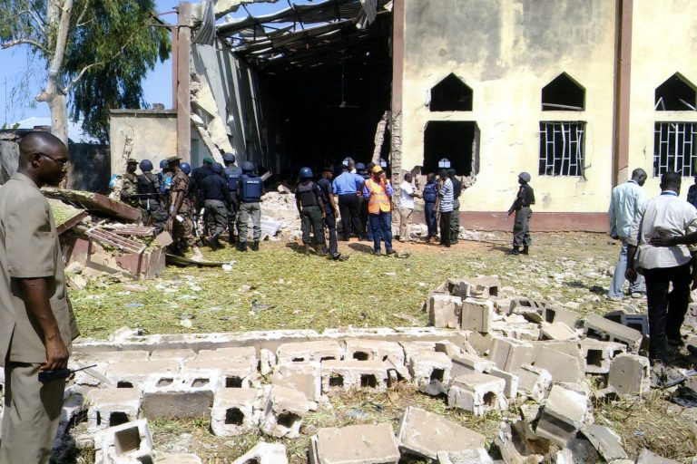 Police and locals outside a church in Nigeria after a terrorist attack