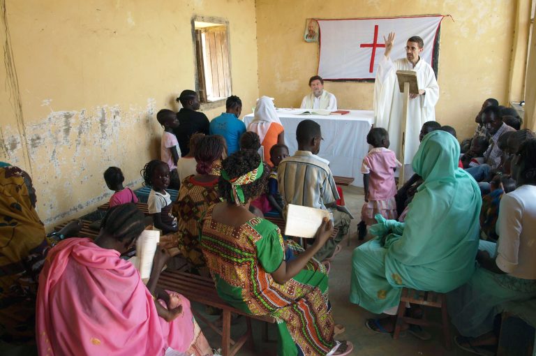 Father Jorge Naranjo, a Combonian priest with his community in Sudan.