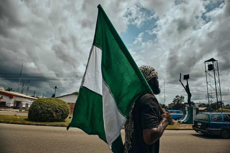 A man with a Nigerian flag in Port Harcourt, Nigeria (© Emmanuel Ikwuegbu)