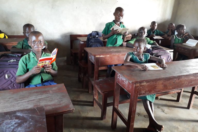Children reading the ACN Child’s Bible in Sierra Leone.