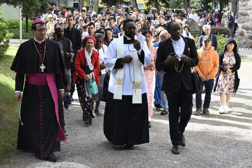 Picture of Bishop Raimo Goyarrola of Helskinki leading parishioners on a prayer walk.